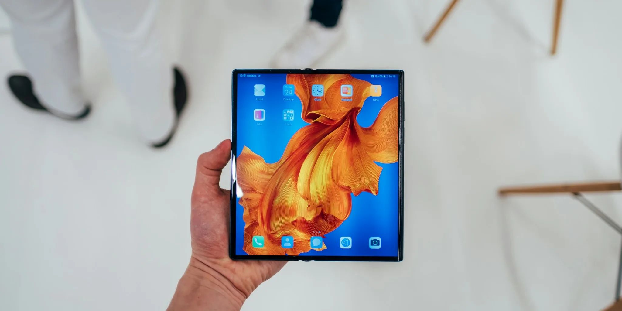 person holding modern folding smartphone screen