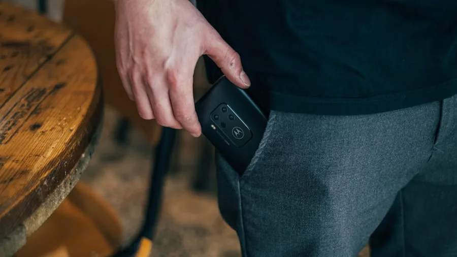 Person holding small portable tech device in hand, demonstrating compact size and portability for travel