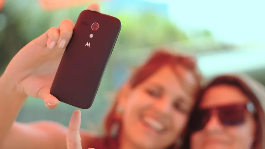 Person holding smartphone while checking connectivity in urban environment
