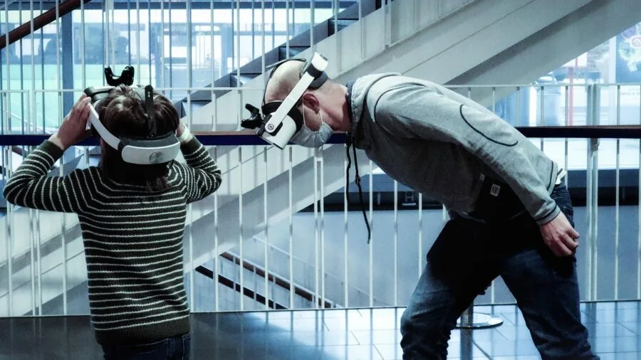 Person immersed in virtual reality gaming experience with motion tracking headset