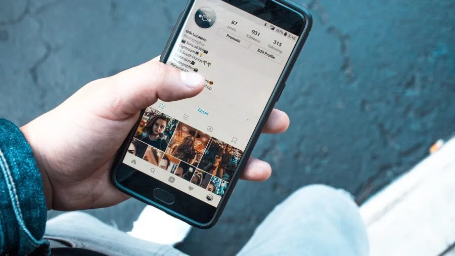 Person in casual setting checking smartphone notifications and messages on mobile device