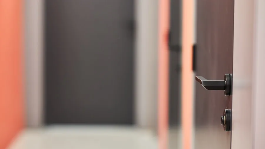 Person installing adhesive mount on apartment door frame without drilling