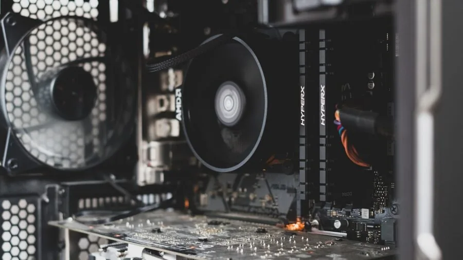 Person installing internal components into a desktop gaming computer motherboard setup