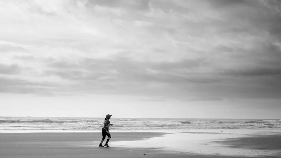 Person jogging outdoors using GPS navigation on wrist device during trail run