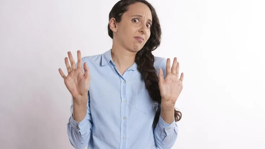 Person looking confused while holding gaming controller, symbolizing compatibility issues with racing simulation gear