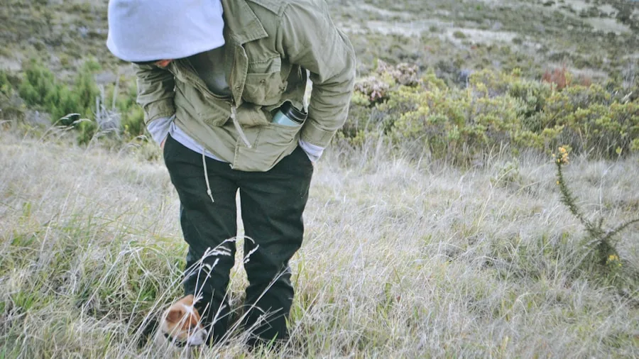 Person looking for lost item in outdoor setting, searching through grass and surroundings