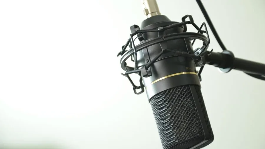 Person making sound system adjustments in home entertainment space