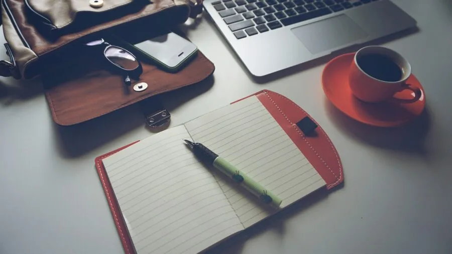 Person managing computer storage and files on laptop at desk workspace