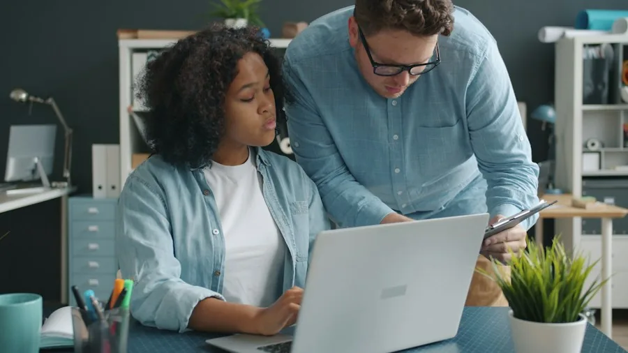 person mentoring colleague office setting
