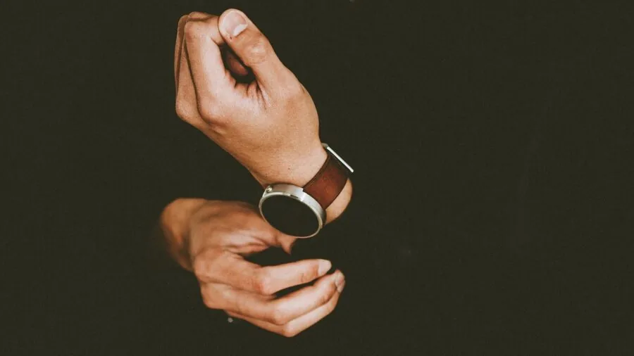 Person monitoring their health and wellness by checking metrics on their wrist device during daily routine