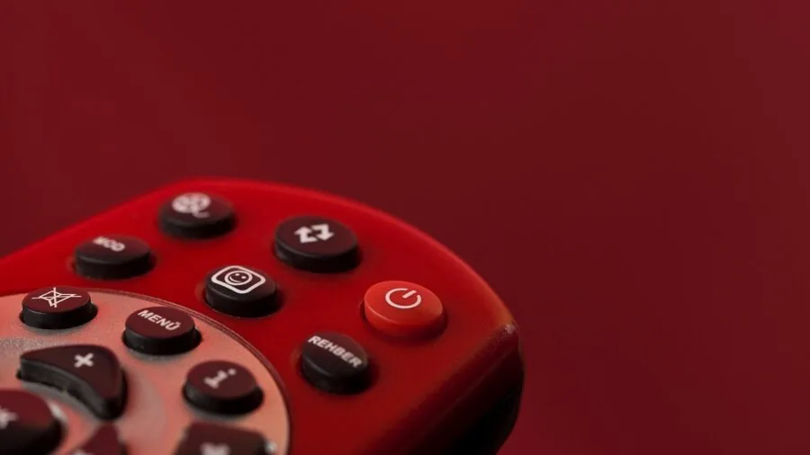 Person navigating smart TV menu with remote control in living room setting