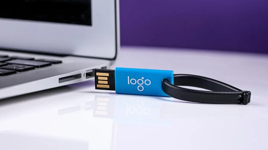 Person organizing digital files and backup devices at a modern desk workspace