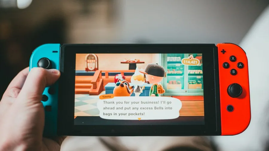 person playing handheld gaming console