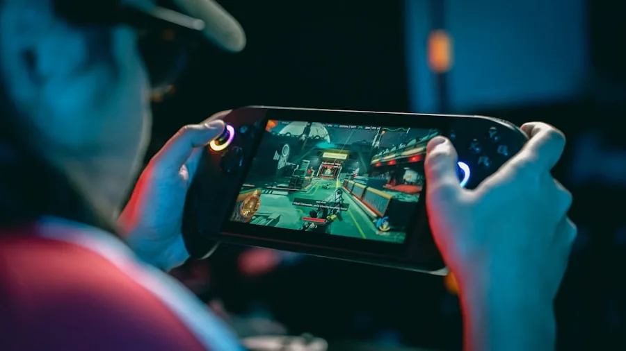 person playing handheld gaming device