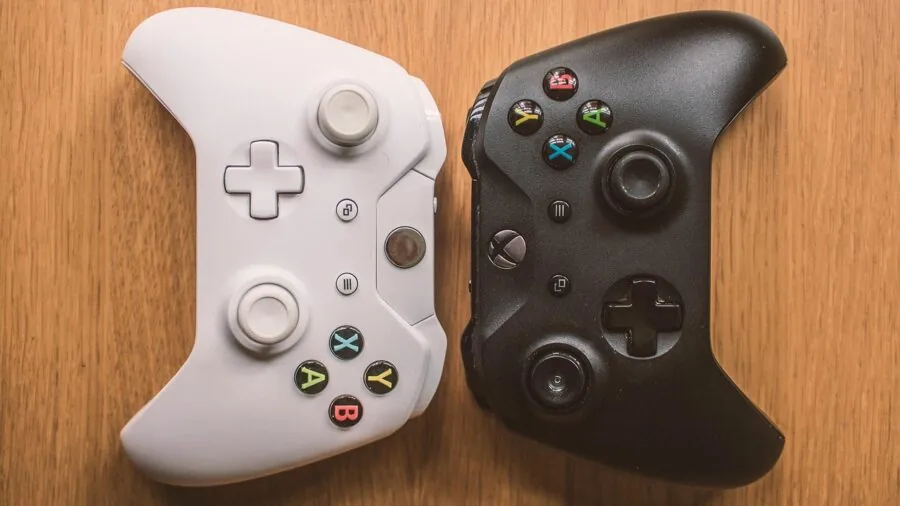 Person playing video game with wireless controller in casual home gaming environment