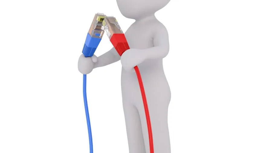 Person plugging cable into computer port during tech setup