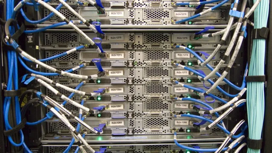Person plugging ethernet cable into back of modem for fast internet connection setup