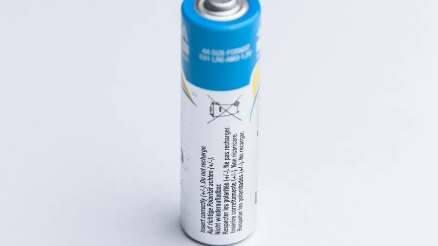 Person plugging in fitness tracker to charge battery during morning routine at home