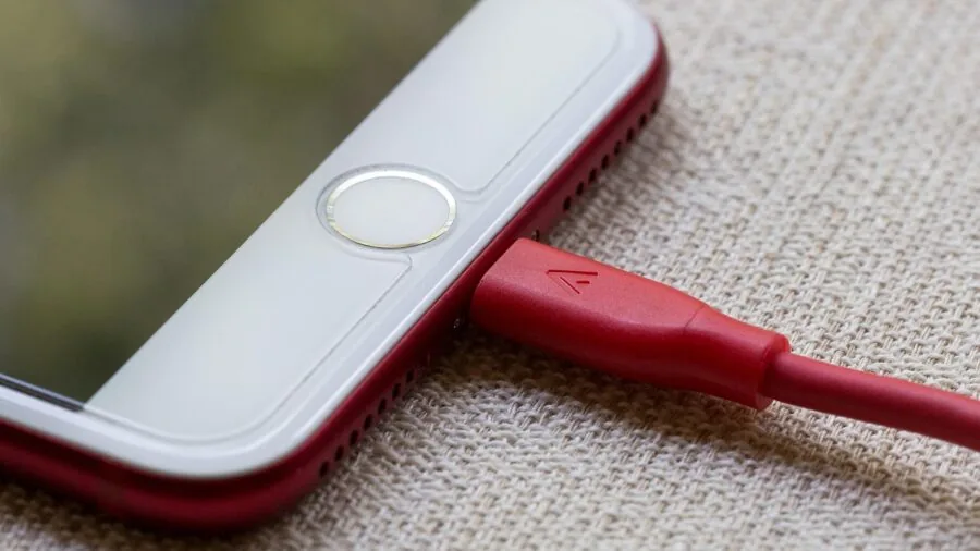 Person plugging USB-C cable into laptop or mobile device for audio connectivity