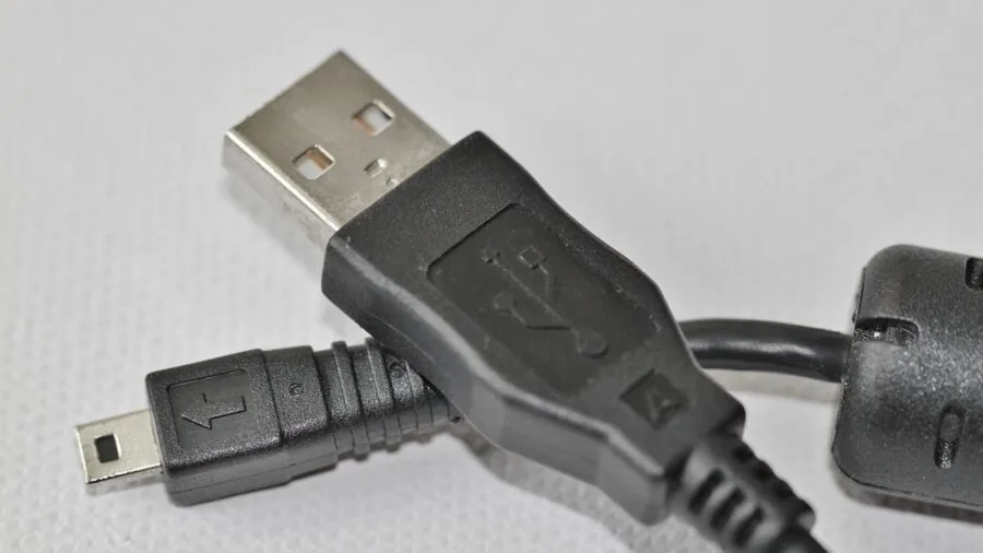 Person plugging USB cable into computer front panel ports during work setup