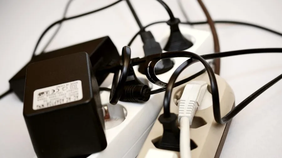 Person plugging USB cables into computer tower ports during PC build setup
