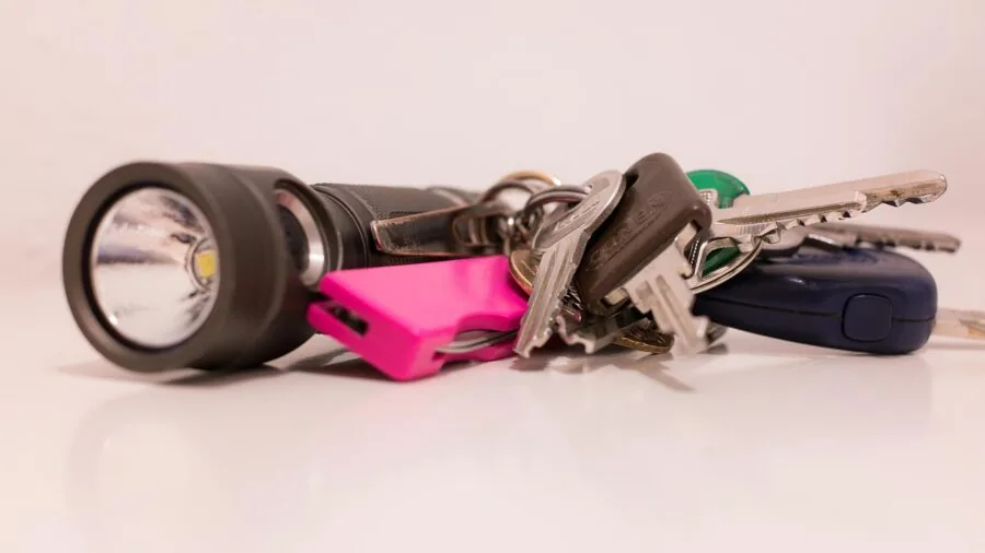 Person reaching into jacket pocket to check keys, demonstrating convenient everyday carry