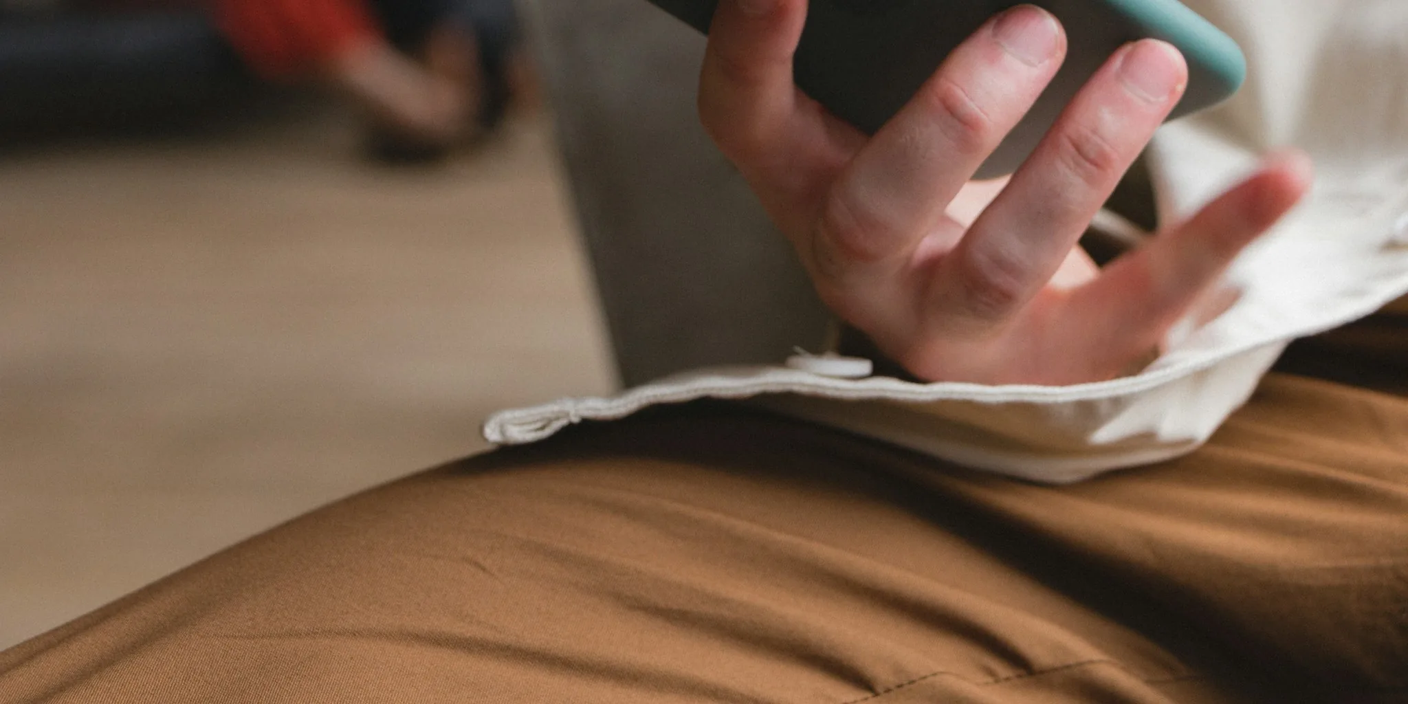 person reading on iPhone relaxed