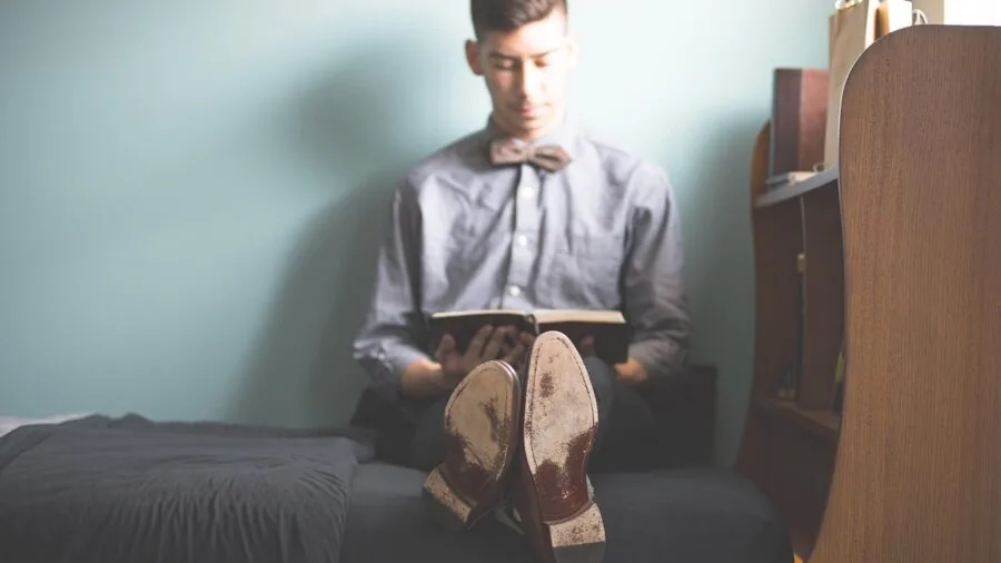 Person relaxing at home enjoying high-quality audio from a soundbar system with enhanced sound technology
