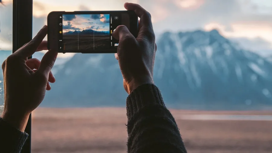 Person reviewing and sharing travel photos on smartphone in natural outdoor setting