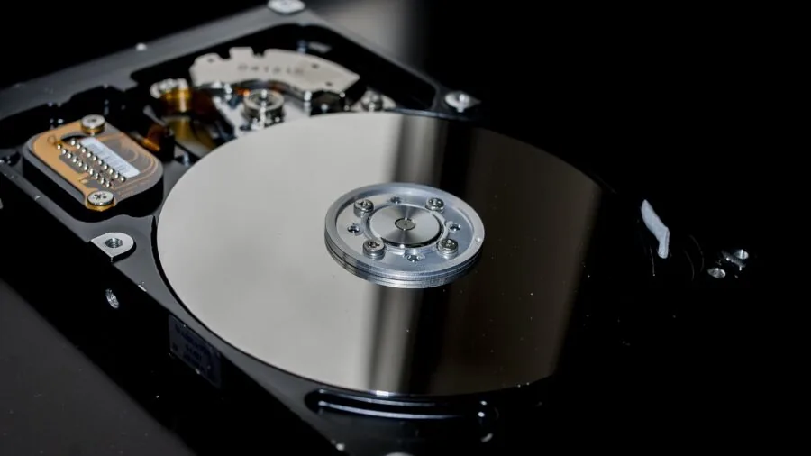 Person reviewing UPS battery backup specifications on laptop in home office setup