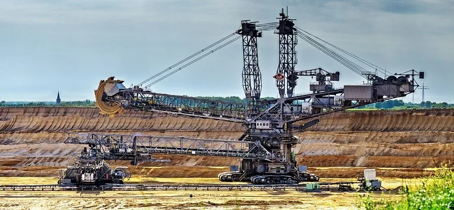 Person rolling heavy equipment on wheels across floor for portability and ease of movement