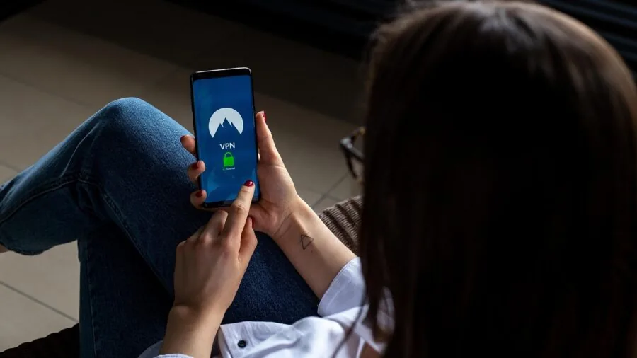 Person securing home network with modern router setup in living room