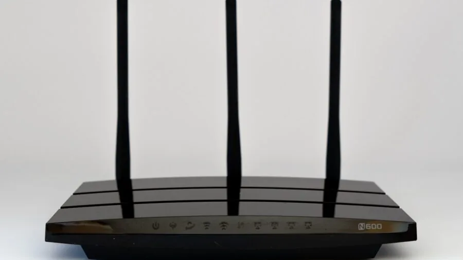 Person setting up wireless network equipment in modern living room for home connectivity