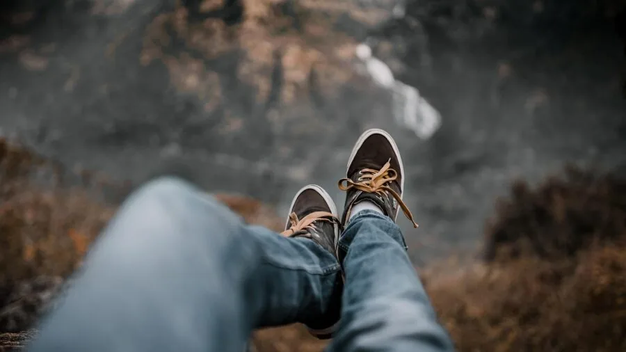 person sitting on bed edge