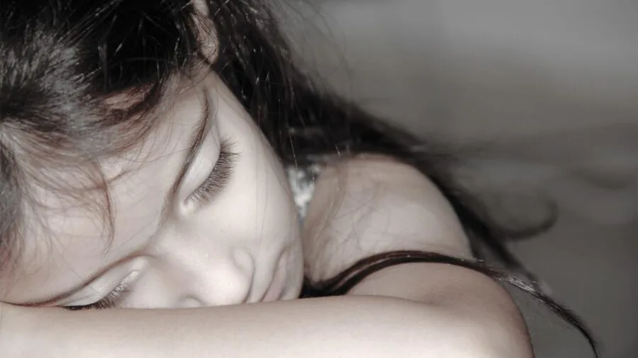 Person sleeping peacefully in bed at night, monitoring health metrics during rest