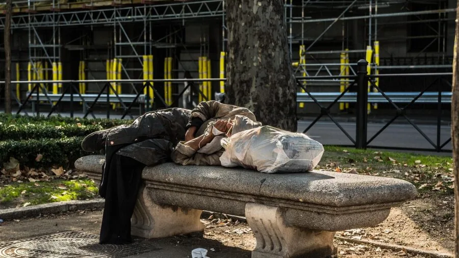 Person sleeping peacefully in bed, representing rest and recovery metrics for fitness tracking