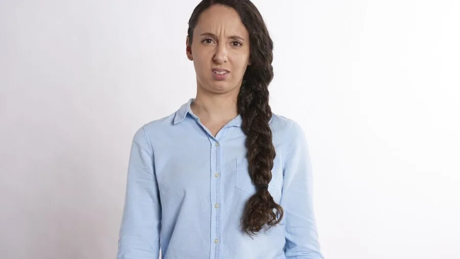 Person studying detailed technical documentation and specifications with confused expression
