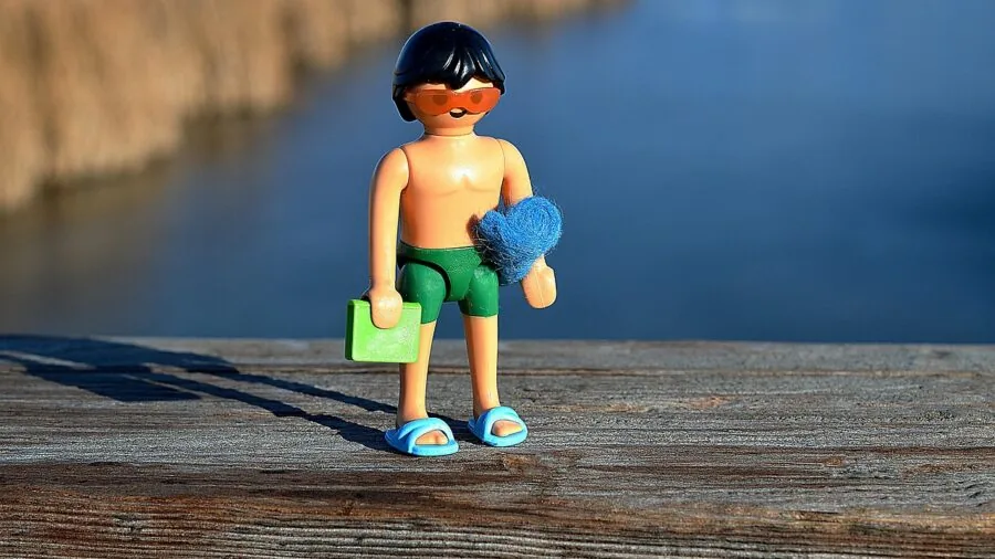 Person swimming in water during outdoor activity, demonstrating water resistance and durability needs