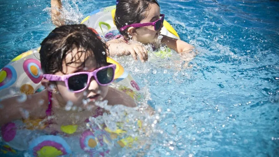 Person swimming underwater during active water exercise, demonstrating water resistance durability needs