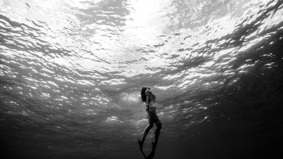 Person swimming underwater during fitness training session