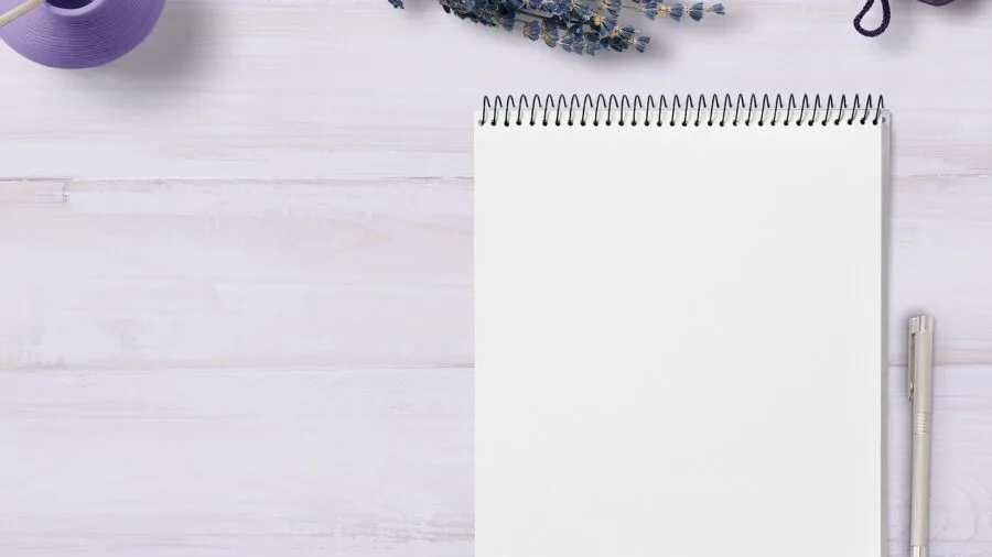 Person taking handwritten notes on tablet with stylus pen in natural lighting