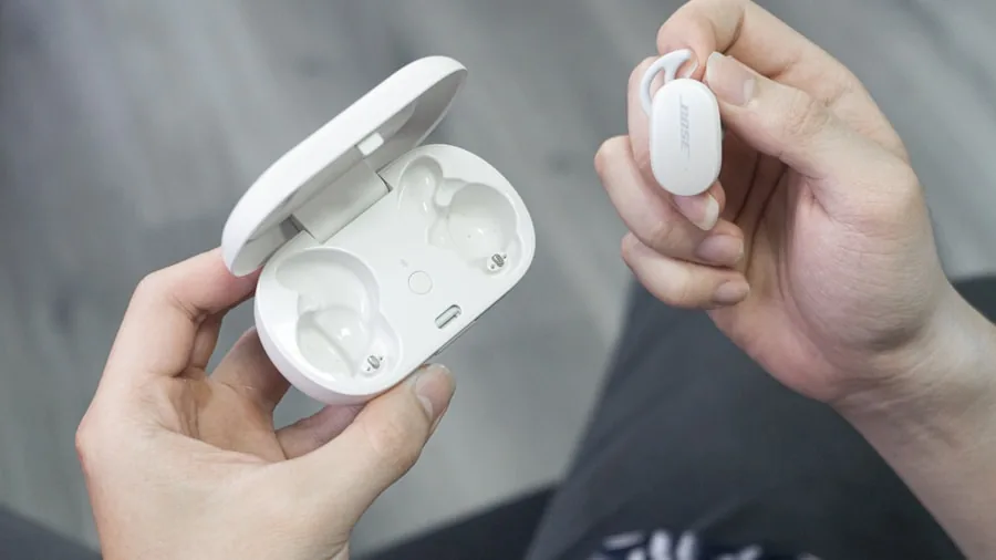 Person testing earbuds for comfort fit and feel in everyday setting
