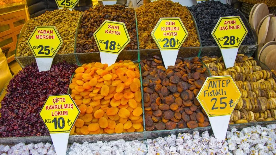 Person thoughtfully comparing different product options while shopping, representing budget decision-making and value assessment