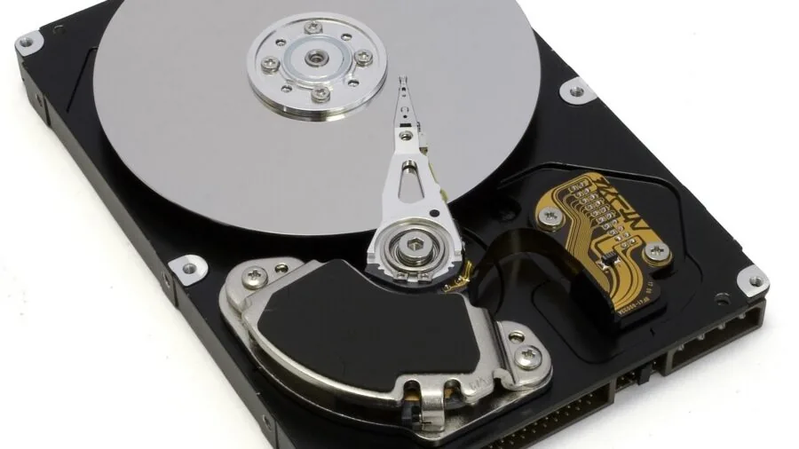 Person transferring files between computer and external storage device with modern cables