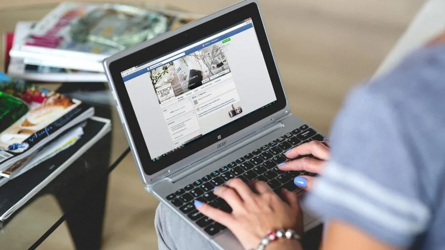 Person typing on keyboard at desk, demonstrating typing posture and hand position during work session