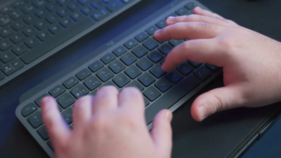 person typing tablet keyboard