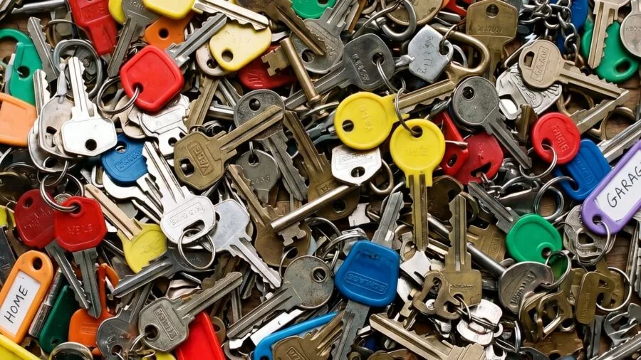 Person unlocking front door with keypad entry system at home entrance