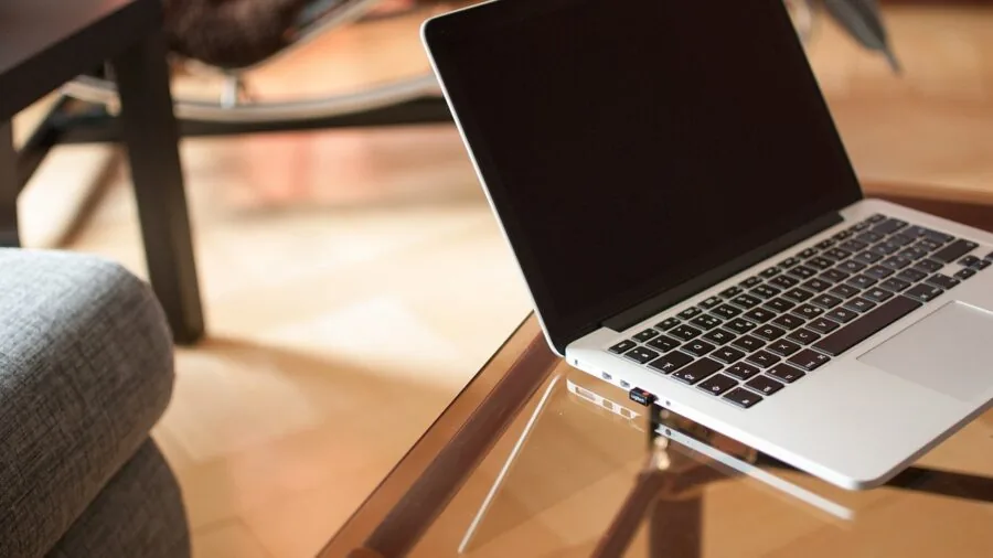 Person using gaming laptop with wireless connection in home environment
