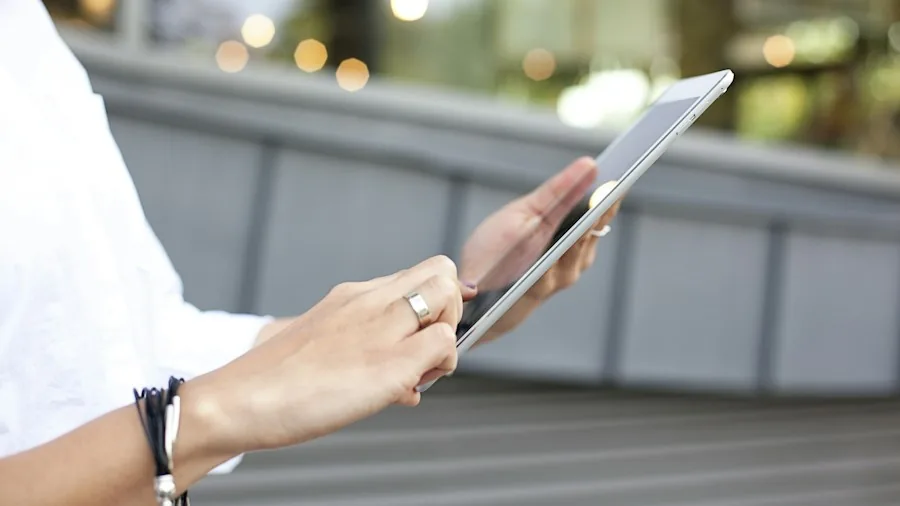 person using iPhone hotspot with tablet