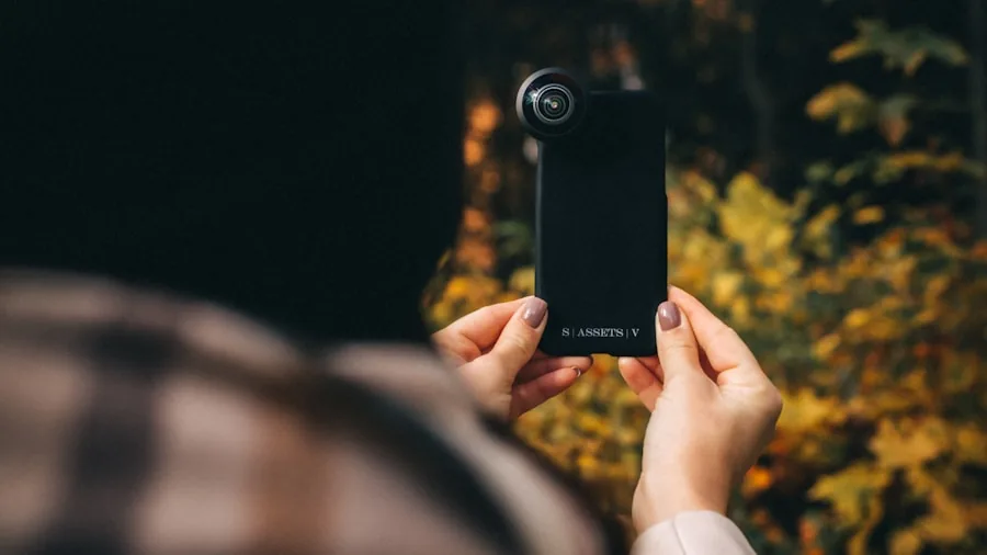 person using phone camera outdoors